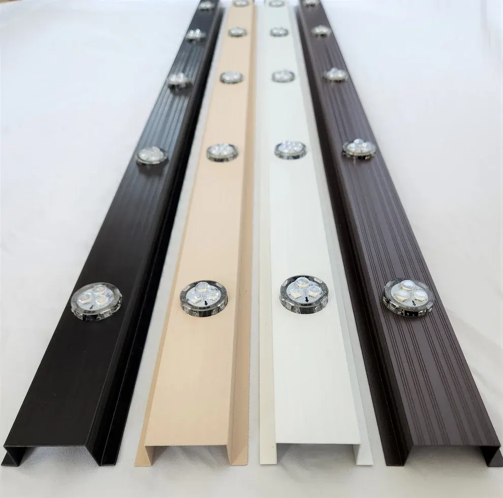 Black, wicker and white aluminum lighting tracks with RGBW pucks side by side