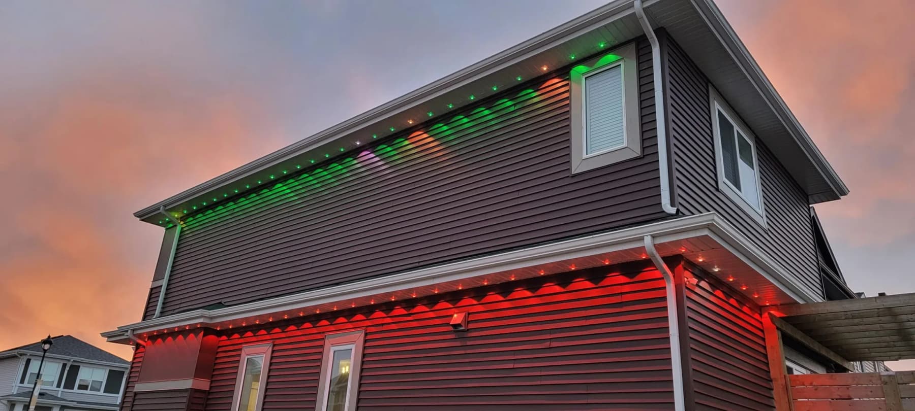 Long home elevation lit end to end with permanent LED track lighting