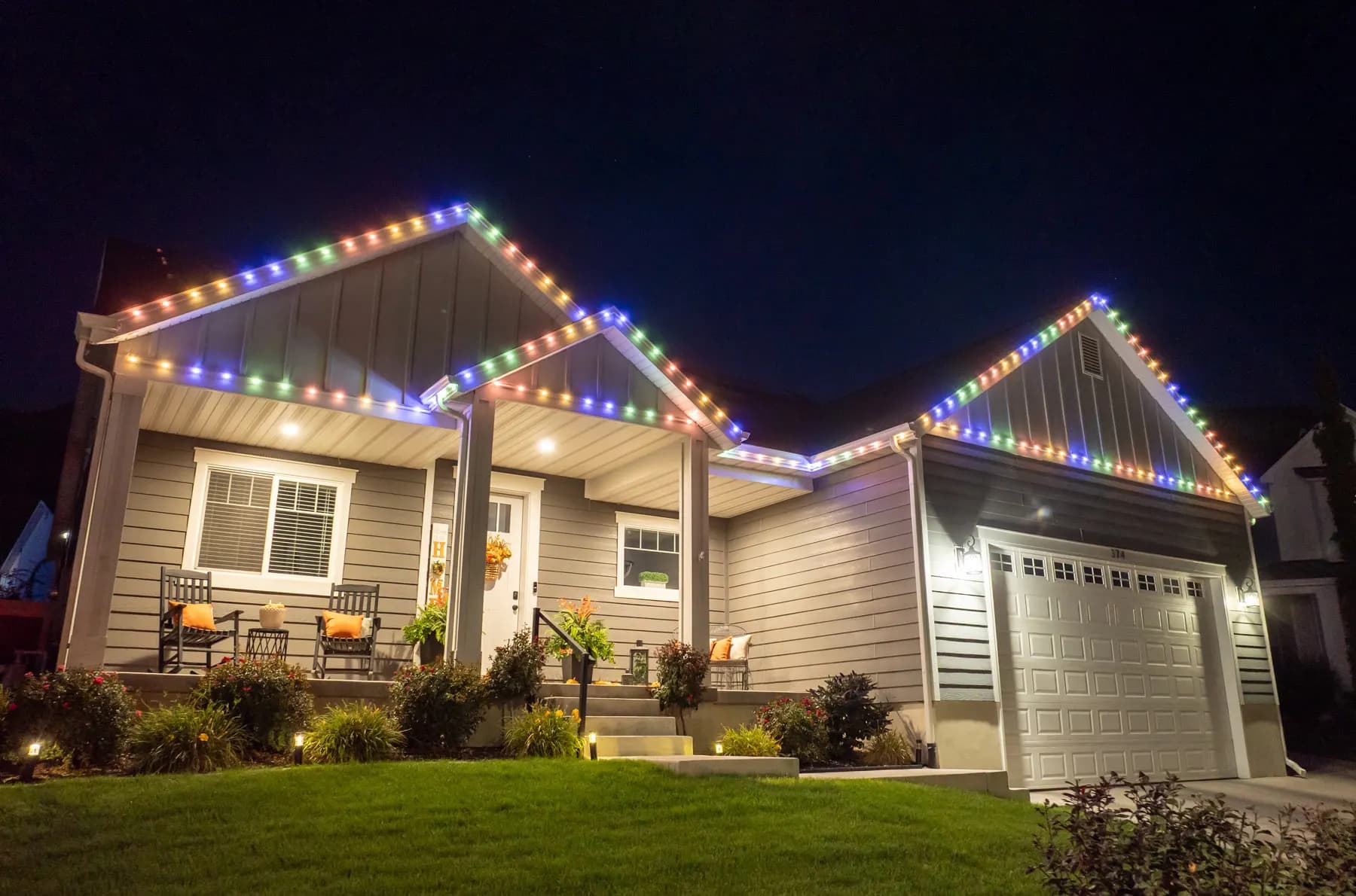 Home with permanent lighting track installed along the roofline in daylight