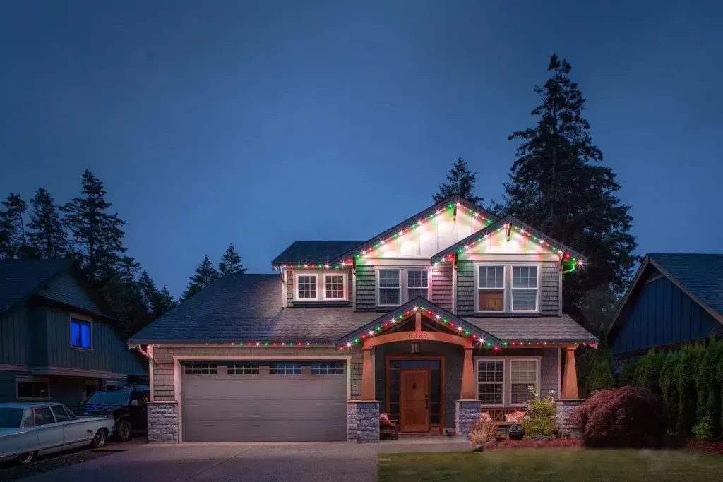 Installer screwing aluminum lighting track into a soffit