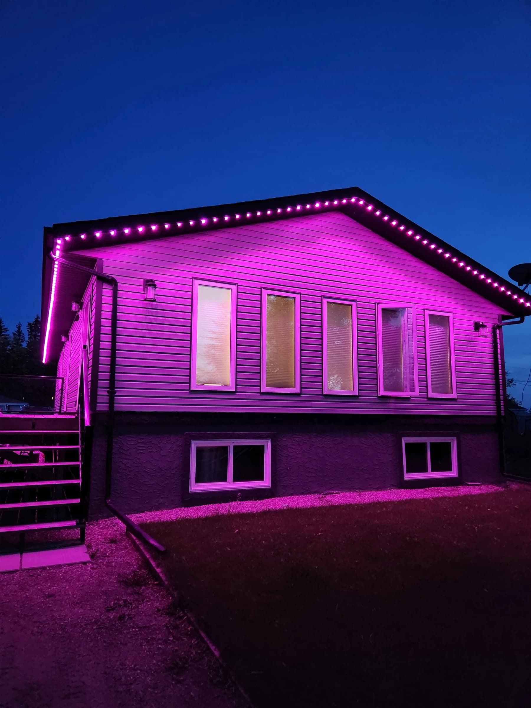 RGBW soffit lighting washing a house facade in pink and magenta